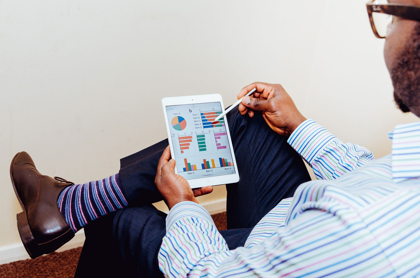 man holding tablet with accounting information on it