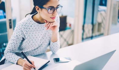 professional woman looks at computer screen